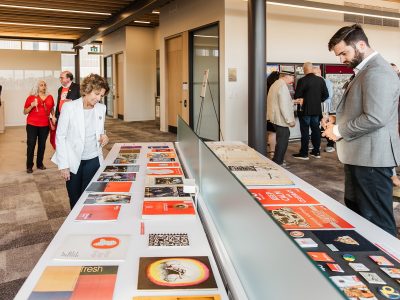 Guests look at displays of historical materials at Brock University's 60th anniversary Skyline Celebration.
