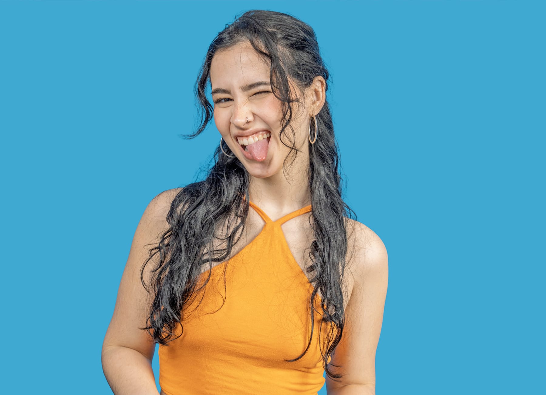 woman in a teasing pose on a blue background