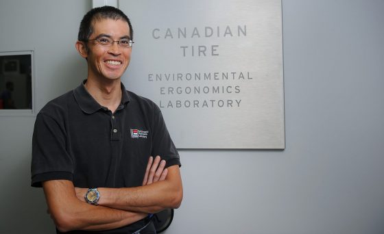 Dr. Stephen Cheung standing in front of a sign that says "Environmental Ergonomics Laboratory"