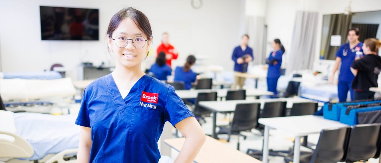 Nursing student poses in nursing lab