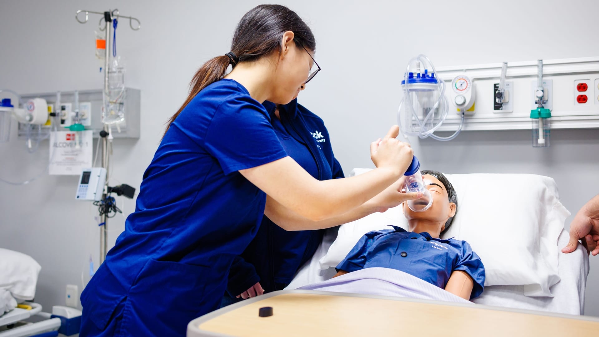 nursing student applying oxygen to a simulated patient