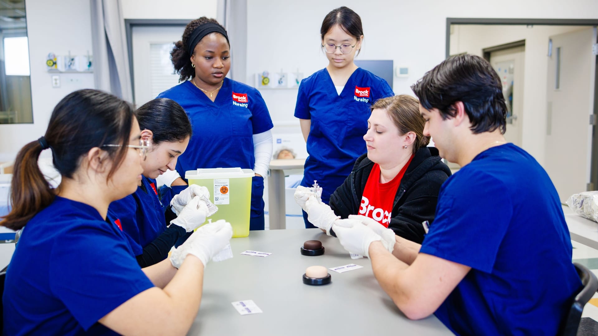 nursing students practicing with needles