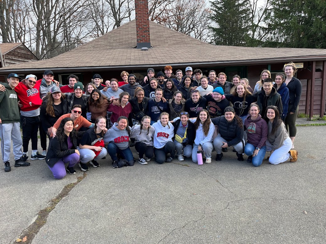 60 student group shot outdoors in front of cabin 