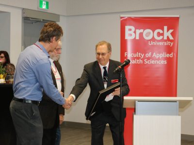 Man shaking hands giving an award