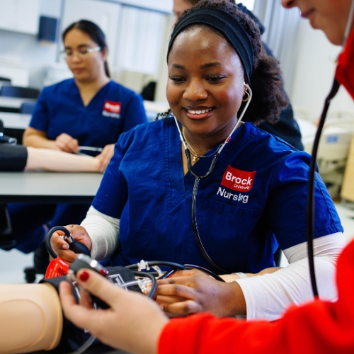 nursing student with blood pressure cuff and stethoscope