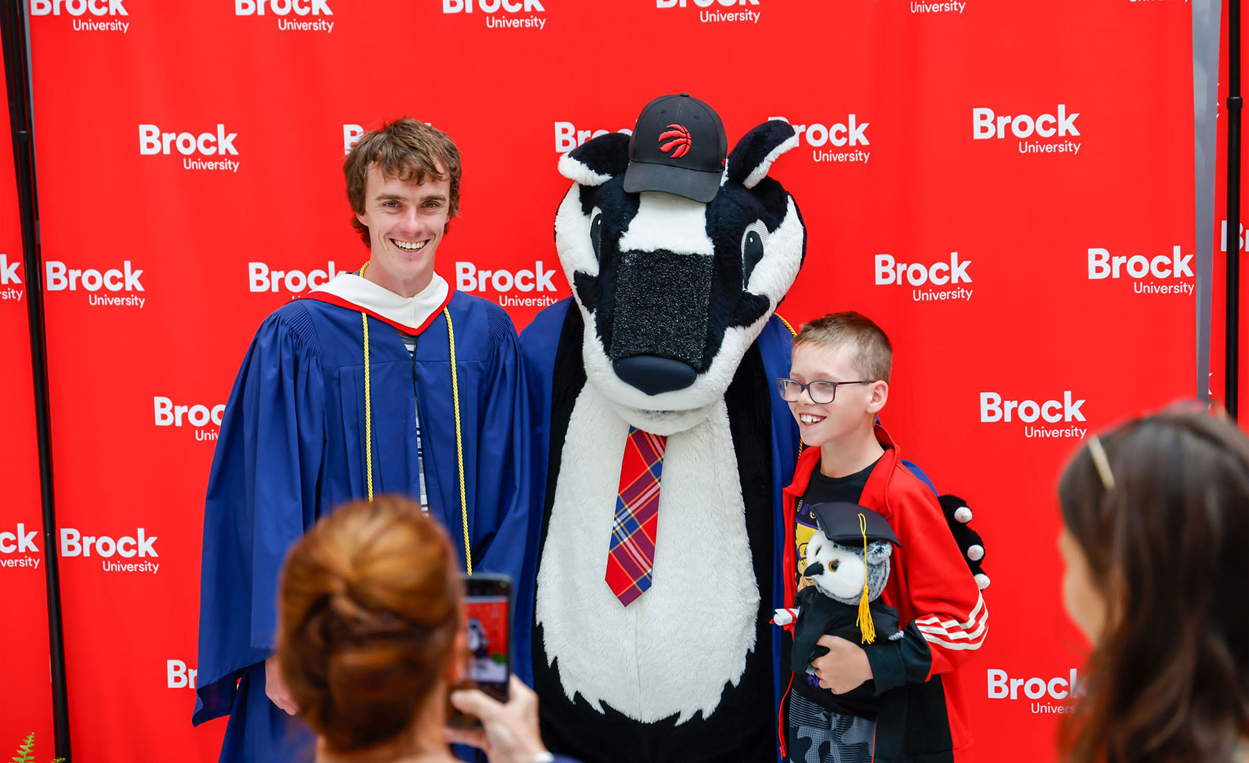 Example of a backdrop being used at convocation to take a photo with Boomer.