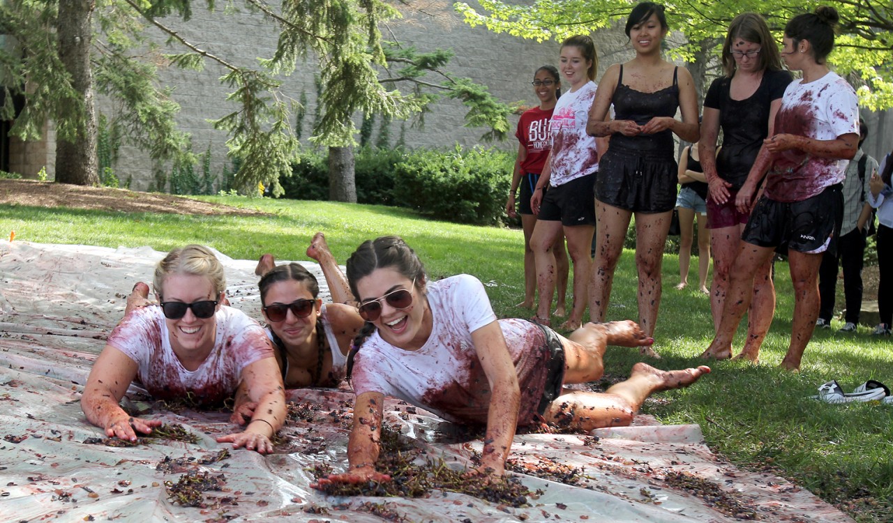 Elisa Damiani, left, Amanda Bava and Emily Sage had fun slipping and sliding during Grape Stomp.