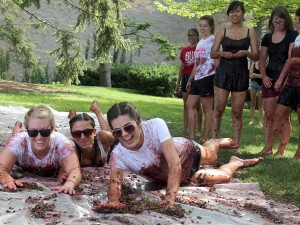 Elisa Damiani, left, Amanda Bava and Emily Sage had fun slipping and sliding during Grape Stomp.