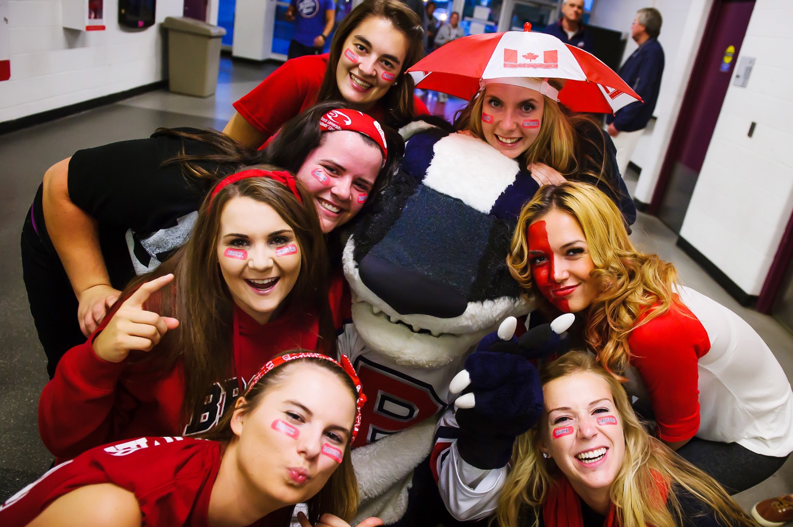Brock University students pose with Boomer the Badger before a hockey game during the 2014 Steel Blade Tournament.