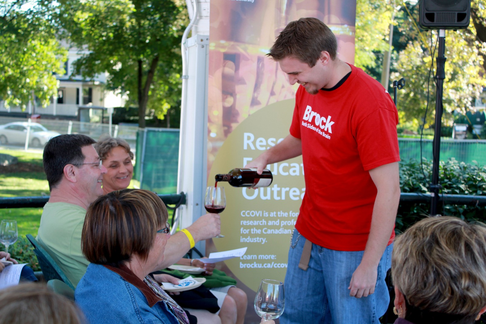 A Brock University volunteer pours wine during the Niagara Wine Festival in this file photo.