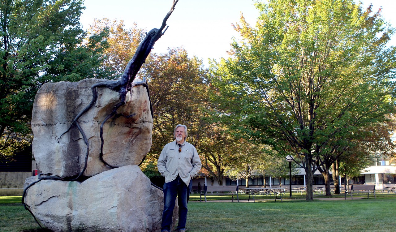 Canadian artist Reinhard Reitzenstein stands beside his sculpture 2000 years on the Edge, which is moving from Jubilee Court where it's pictured, to a spot between the Plaza Building and Cairns Complex.