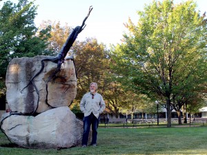 Canadian artist Reinhard Reitzenstein stands beside his sculpture 2000 years on the Edge, which is moving from Jubilee Court where it's pictured, to a spot between the Plaza Building and Cairns Complex.
