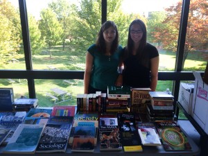 Brock University's Archaeological Society co-president Olivia Holcombe, left, and Sydney Bryk sell books in the Mackenzie Chown building Wednesday, Sept. 16.