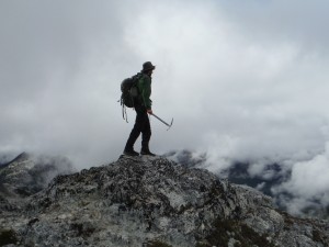Man standing on a mountain with clouds