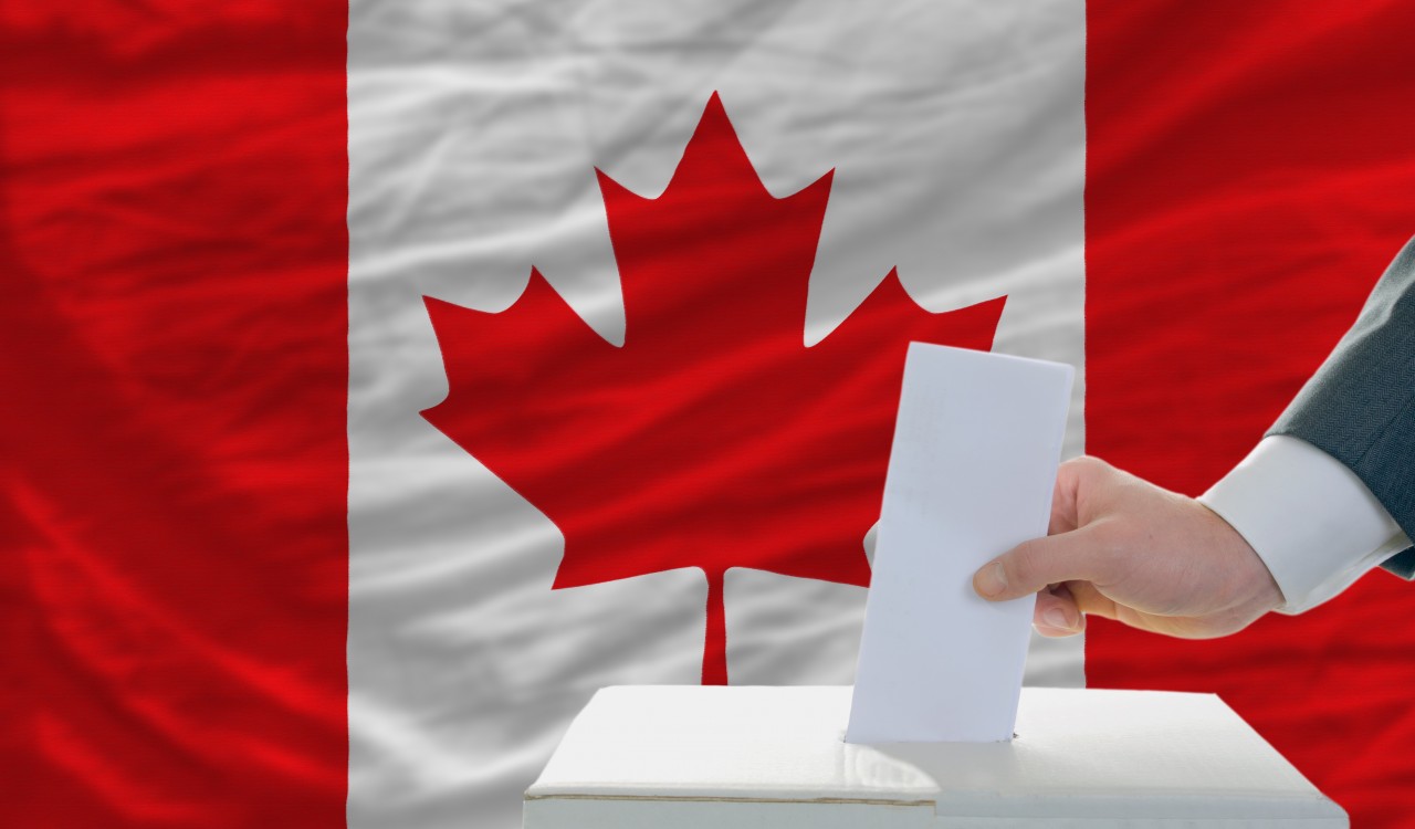 Man puts ballot in voting box in front of Canadian flag in this graphic.