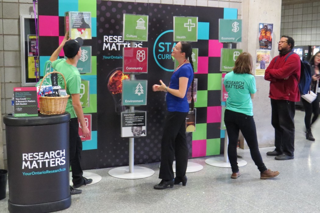 Students check out the Research Matters Curiosity Cruiser, which has a Q&A display of the greatest inventions past and present from university researchers across Ontario.