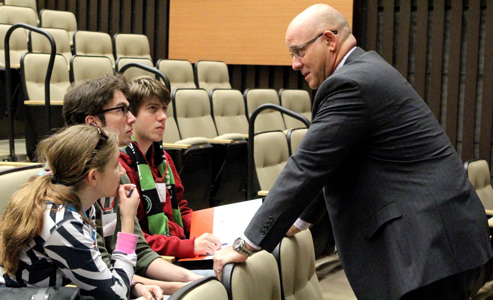 Brock University Vice-President of Finance and Administration Brian Hutchings talks to Grade 12 Eastdale Secondary School students Jenny Schaefer, Malcolm Allcorn and Luc Grenier, Oct. 14 during the Niagara Student Summit.