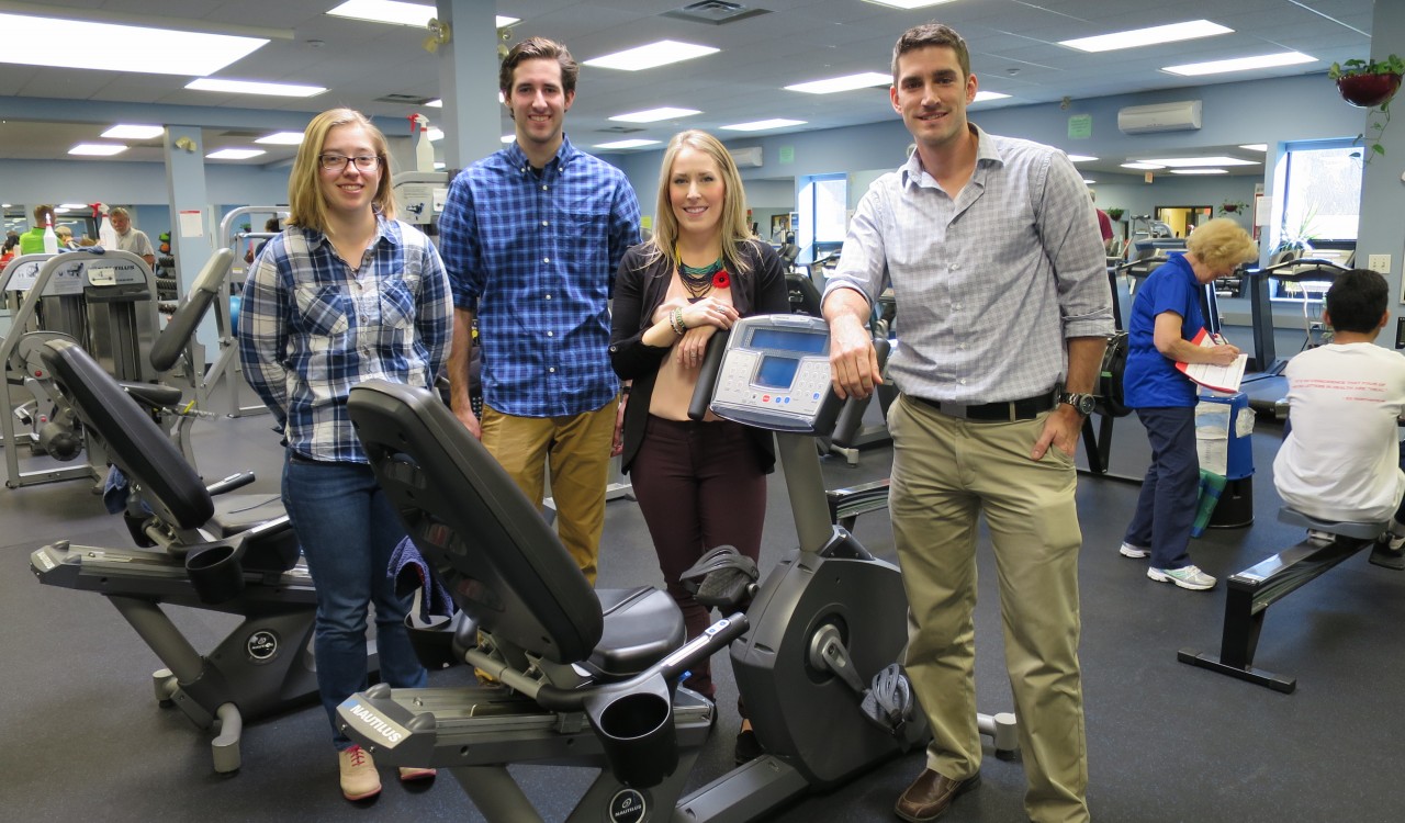 Students in front of an exercise machine