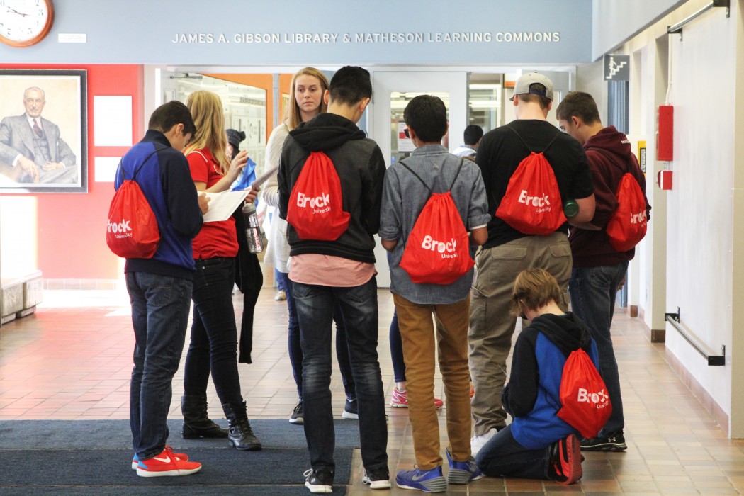 Grade 9s gather in the tower for a scavenger hunt.