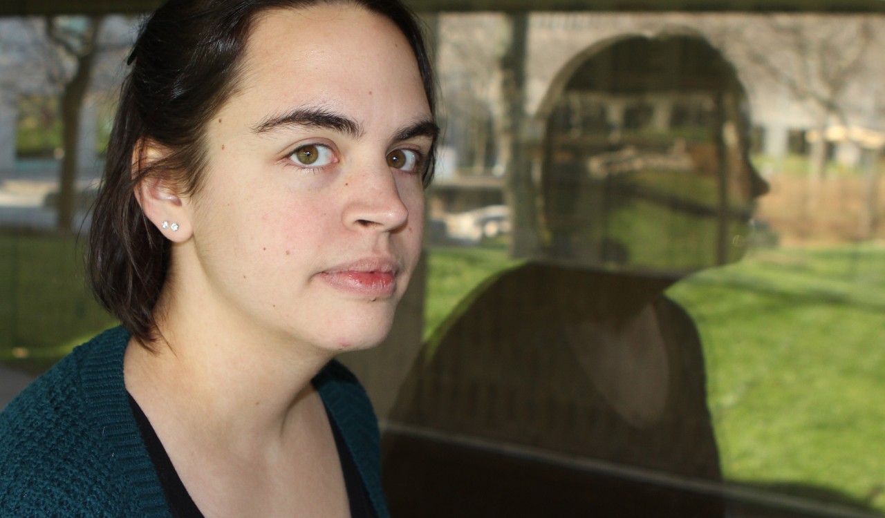 A student reflected in a window.