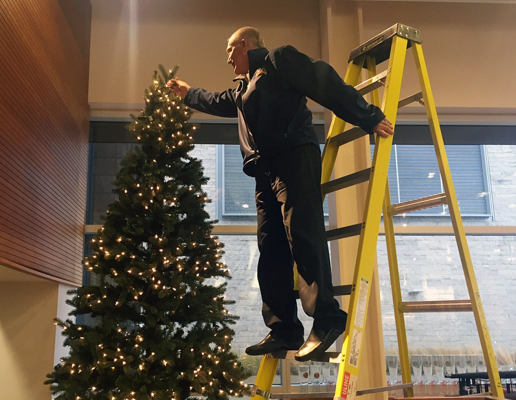 Someone decorating a Christmas Tree