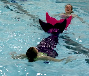 Annika Mazzarella, in pink, and Ashleigh Baxter try out mermaid tails in the pool at Brock University Tuesday, Nov. 17.