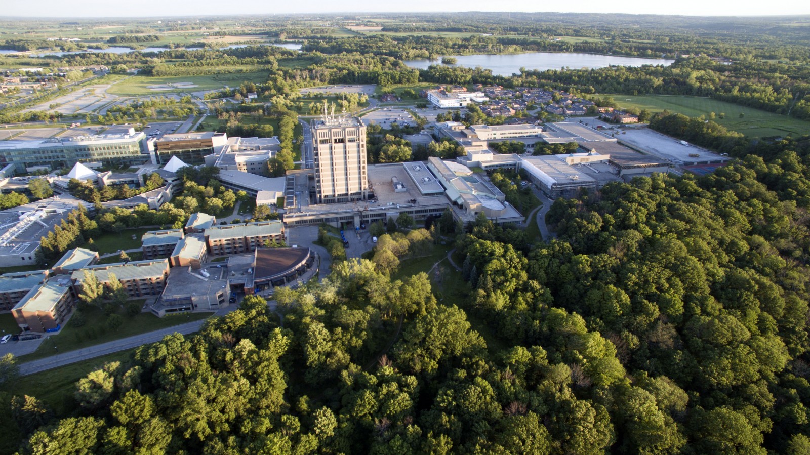 An aerial view of a school campus surrounded by trees.