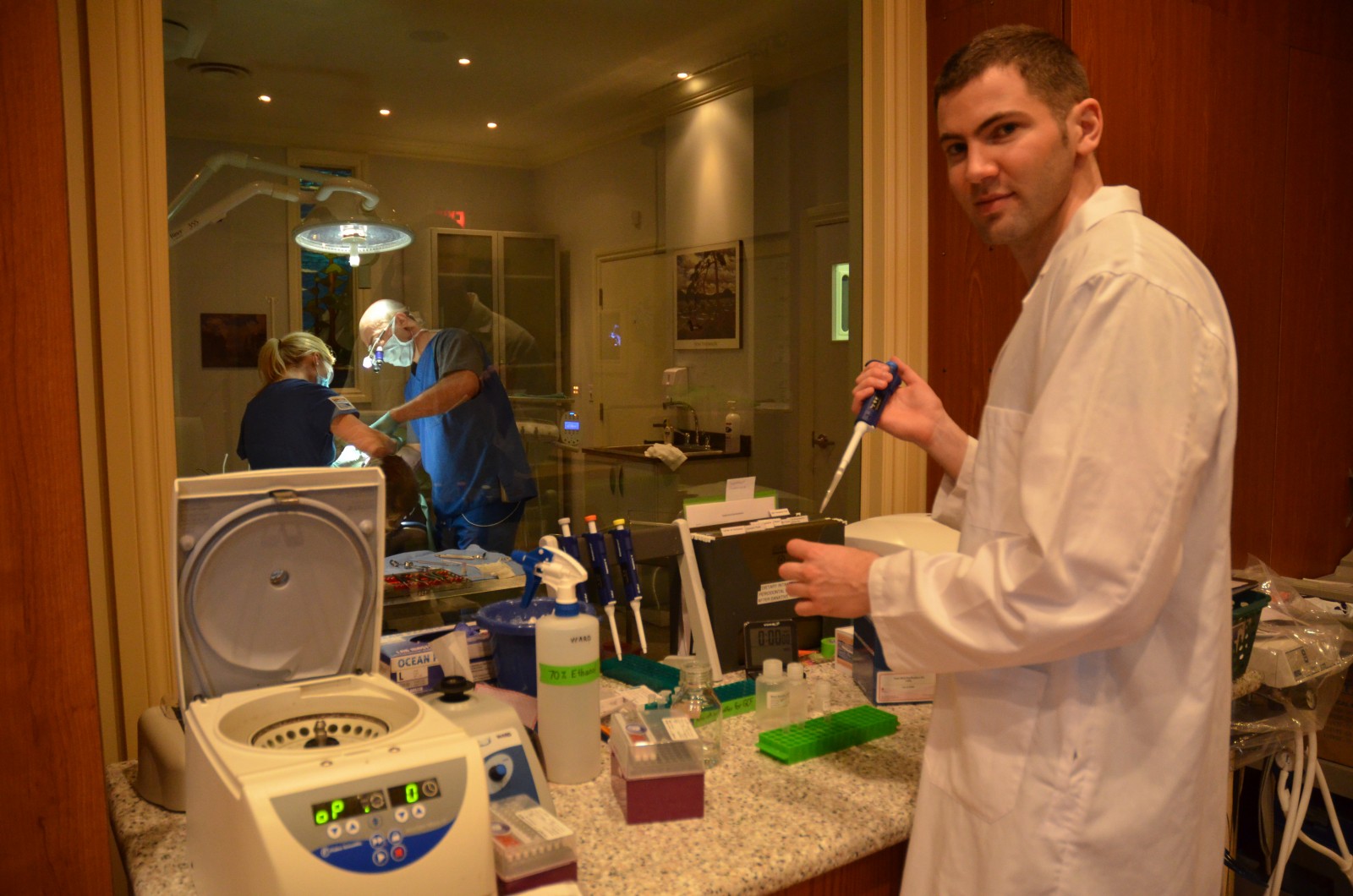 Graduate student David Dodington, foreground, as part of the Brock team researching the impact of nutrition on non-smokers recovering from treatment for periodontal disease. In the background is local periodontist Dr. Peter Fritz.