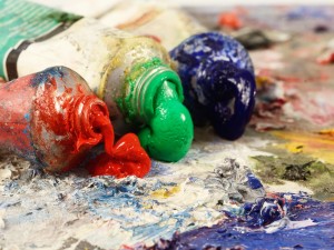 Art still life - closeup of three oil paint tubes with red,green and blue colours ,background for creative art design
