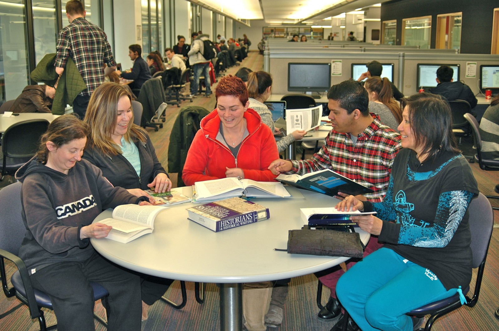 Hitting the books in Brock's Matheson Learning Commons: From left, Jennifer Nixon, Toronto (Mohawk nation) who is studying Film Studies; Jody General, Ohsweken (Mohawk), in Business Administration; Terra Wott, St Catharines (Mi'kmaq), double major honours Psychology and Women’s and Gender Studies; Ryan H. Wijesirigunawardenae, Niagara (Dene), Medical Sciences with minors in Labour Studies, Biology, Physics; and Beverly Bannon, Anemki-wajiw (Thunder Mountain) (Ojibway), Master’s in Education Curriculum Development with minor in Aboriginal Studies.