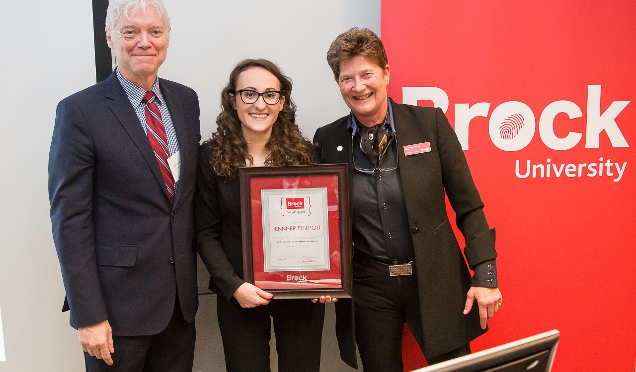 Jennifer Philpott, middle, received the Co-op Student of the Year Award for 2015 from Interim Dean of the Goodman School of Business Barry Wright and Vice-Provost of Teaching and Learning Anna Lathrop.