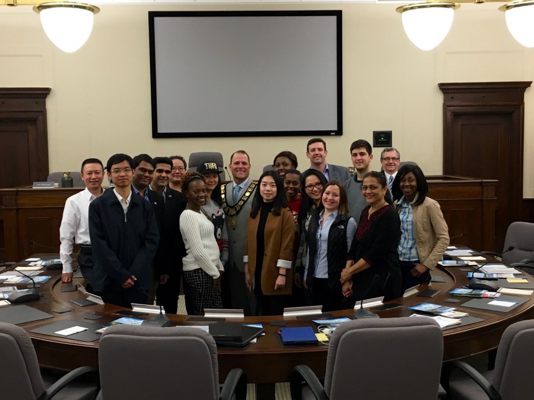 Brock University international students get a picture with St. Catharines mayor Walter Sendzik in council chambers.