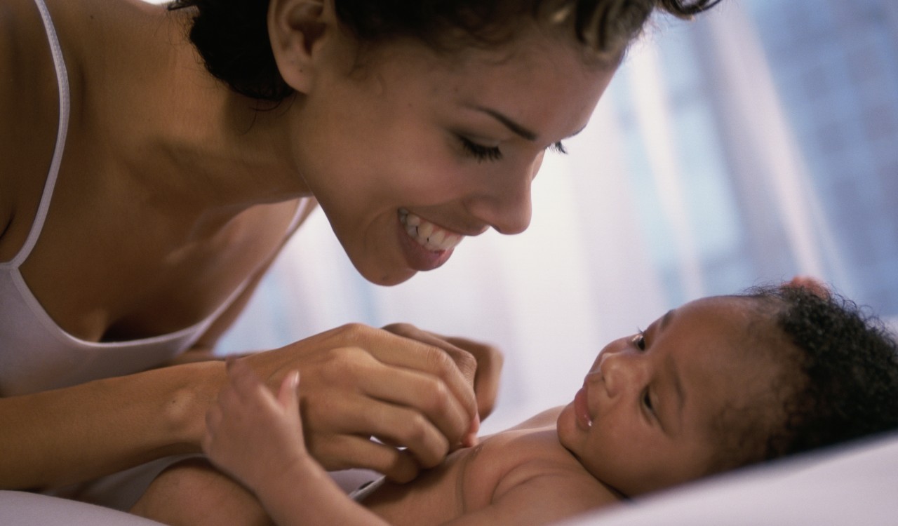 Close-up of a mother playing with her baby boy