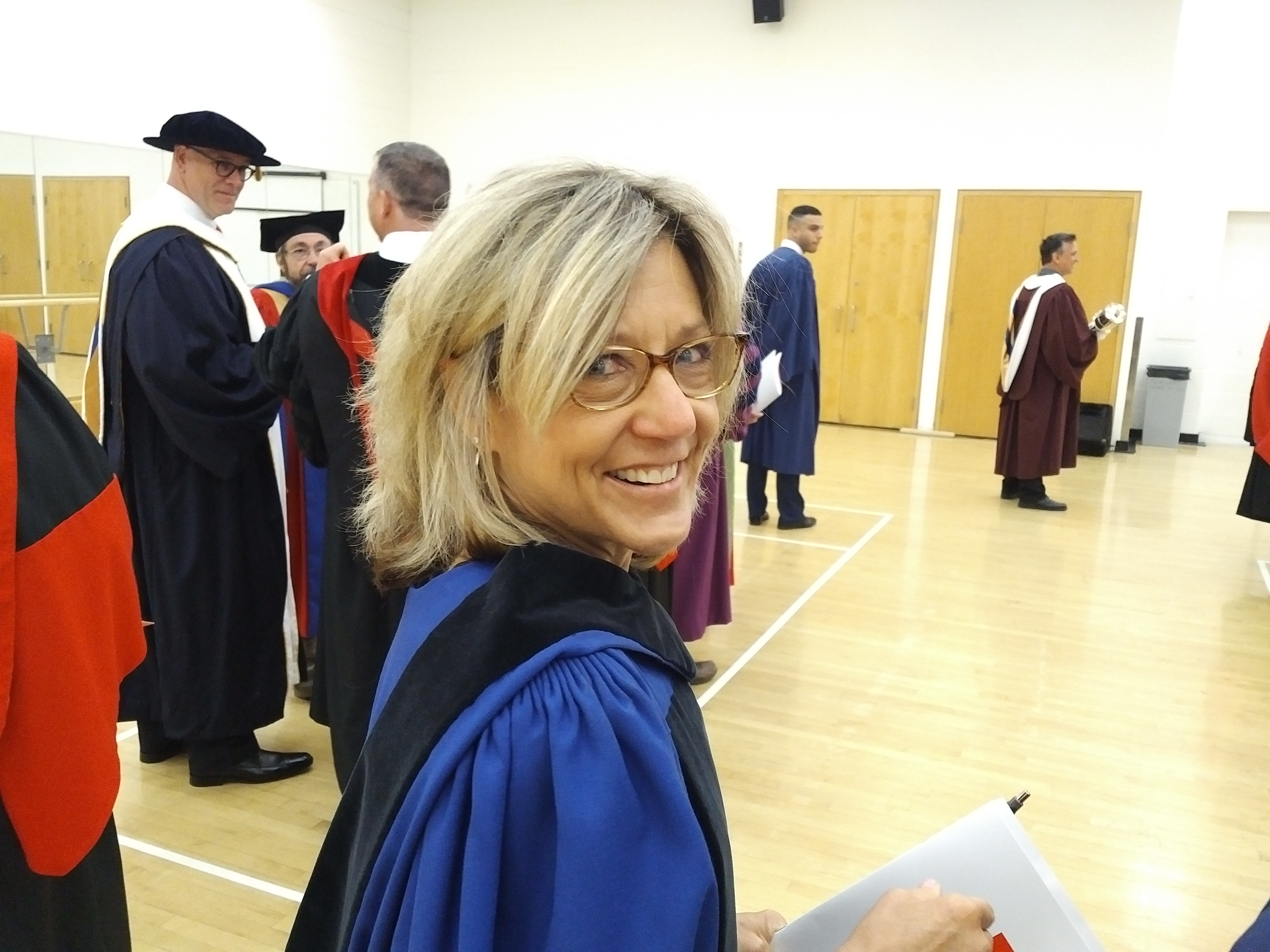 Registrar Barb Davis in the gowning room preparing for Spring convocation. 
