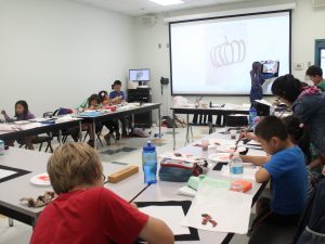 Participants in last year's Chinese language and culture summer camp makes crafts.