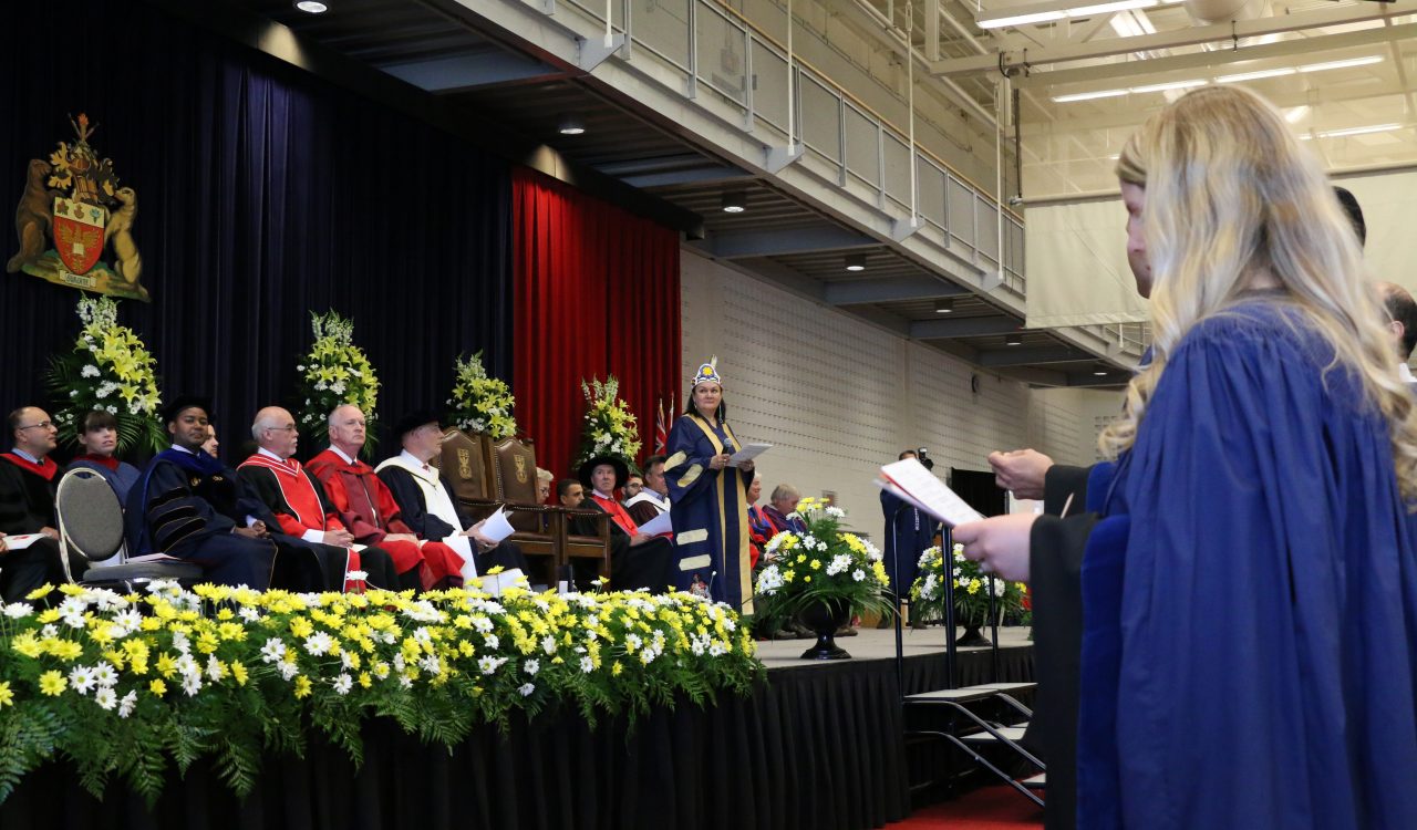 Chancellor Shirley Cheechoo confers graduates Thursday.