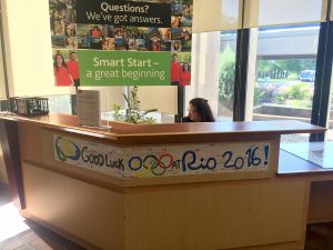 Alli Whitworth, Welcome Desk co-ordinator, works in the lobby of the tower Monday, where a Rio banner has been posted.