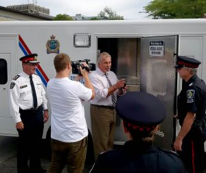 Brock Sports Director Neil Lumsden was mock arrested Wednesday as Niagara Regional Police Chief Jeff McGuire, left, looks on.