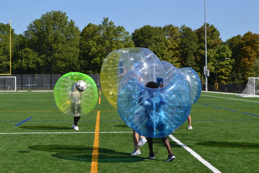 Goodman Business Students' Association member Josh Sayers bounces off an opponent during Bubble Soccer, a part of the #GoodmanSpirit Week festivities.