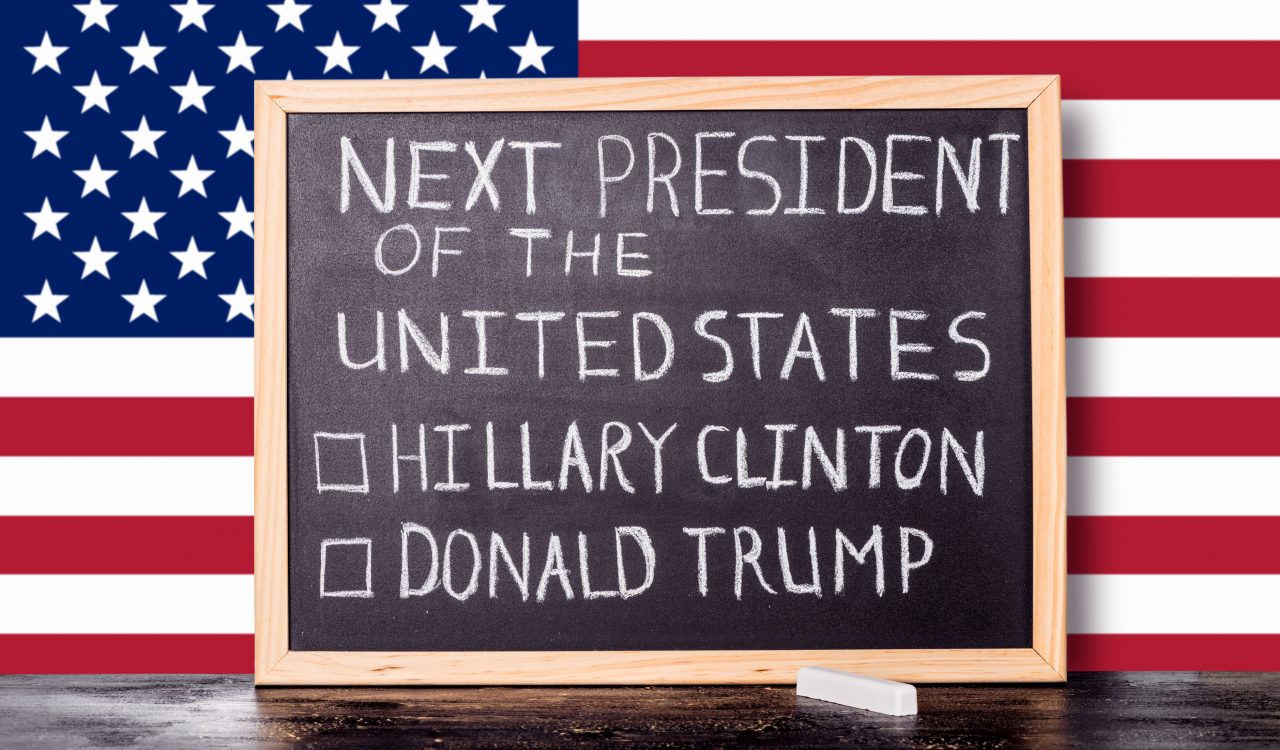 American election concept with flag and handwriting text next president of United States Donald Trump Hillary Clinton written in chalkboard background, close up
