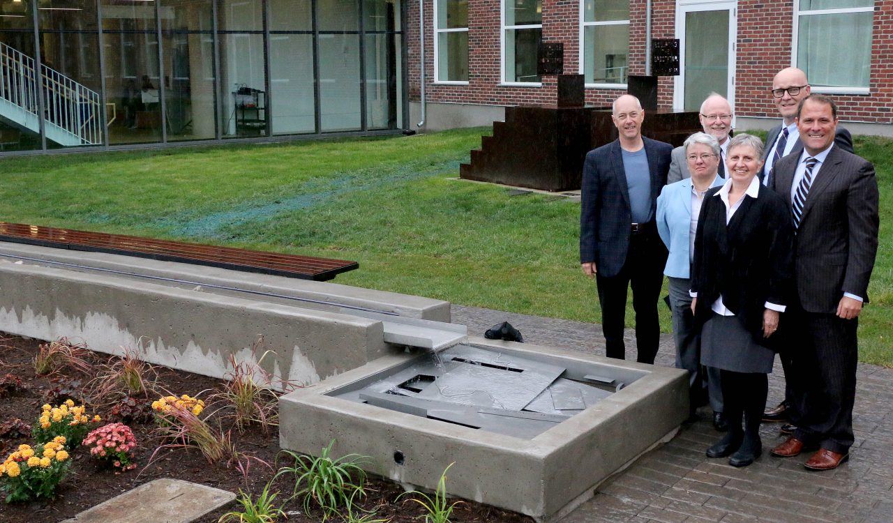 Rotary Club of St. Catharines members George Darte, left, and Liz Palmieri, front, with Mayor Walter Sendzik, right and Brock University Dean of Humanities Carol Meriam, Interim President Tom Traves, back middle, and Vice President of Administration Brian Hutchings, back right, at the unveiling of the new Rotary Reflecting Pool water feature at the Marilyn I. Walker School of Fine and Performing Arts. The water feature was dedicated to the Rotary club to recognize its generous donation to the University.