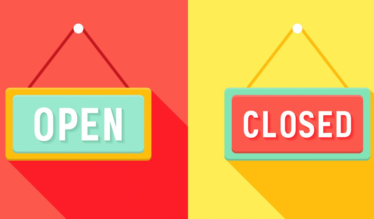 A series of four green and red open and closed signs in front of red and yellow backgrounds.