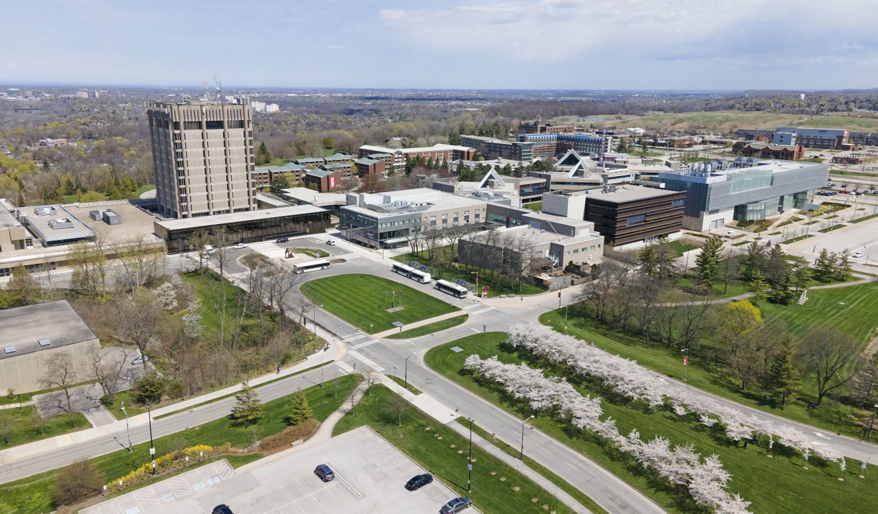 Brock University's main campus with greenery and a series of buildings, including a tall tower.