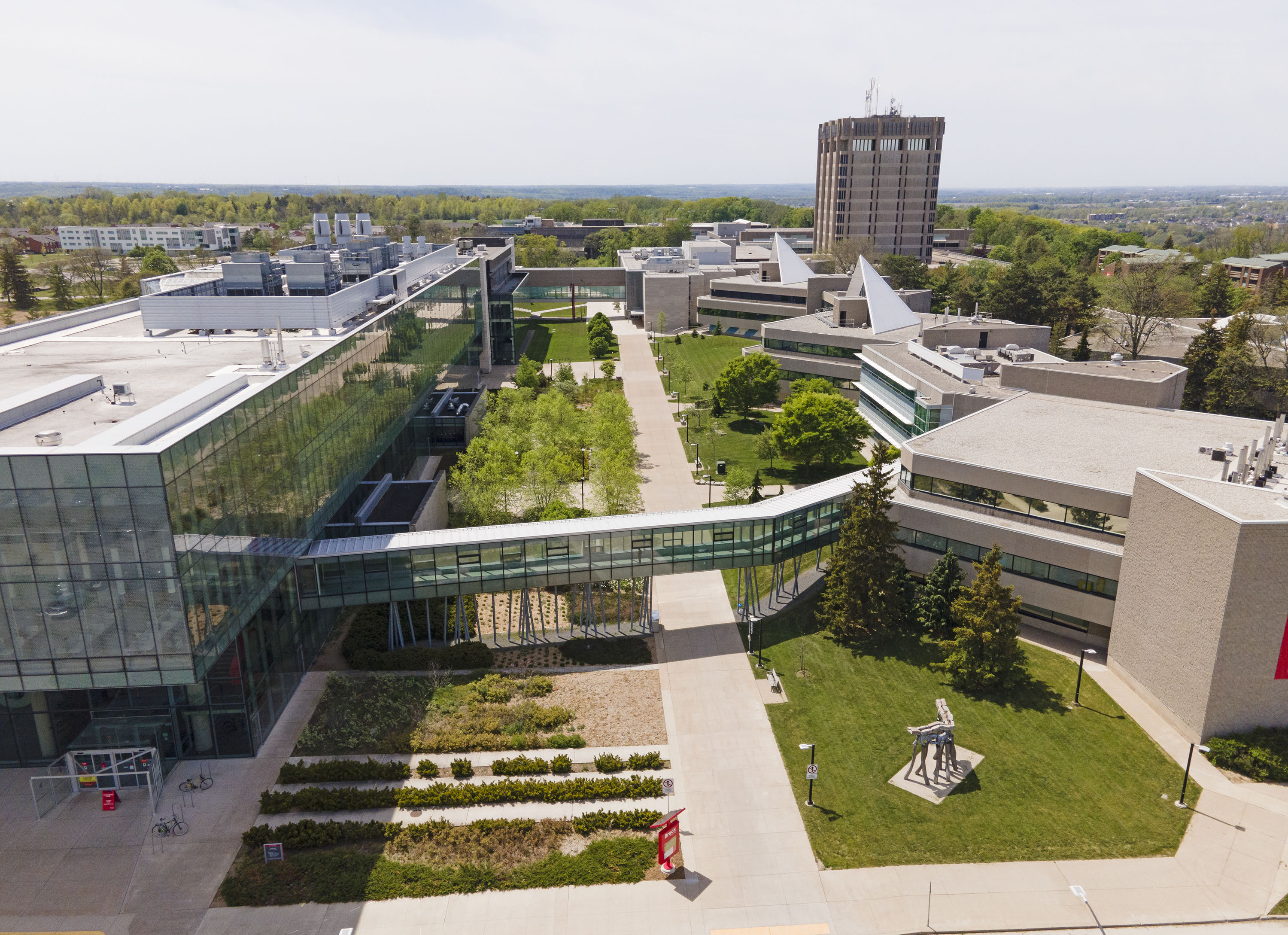 An aerial photo of Brock’s main campus with the Mackenzie Chown complex on the right, the Roy and Lois Cairns Health and Bioscience Research Complex on the left and the Schmon Tower in the distance.