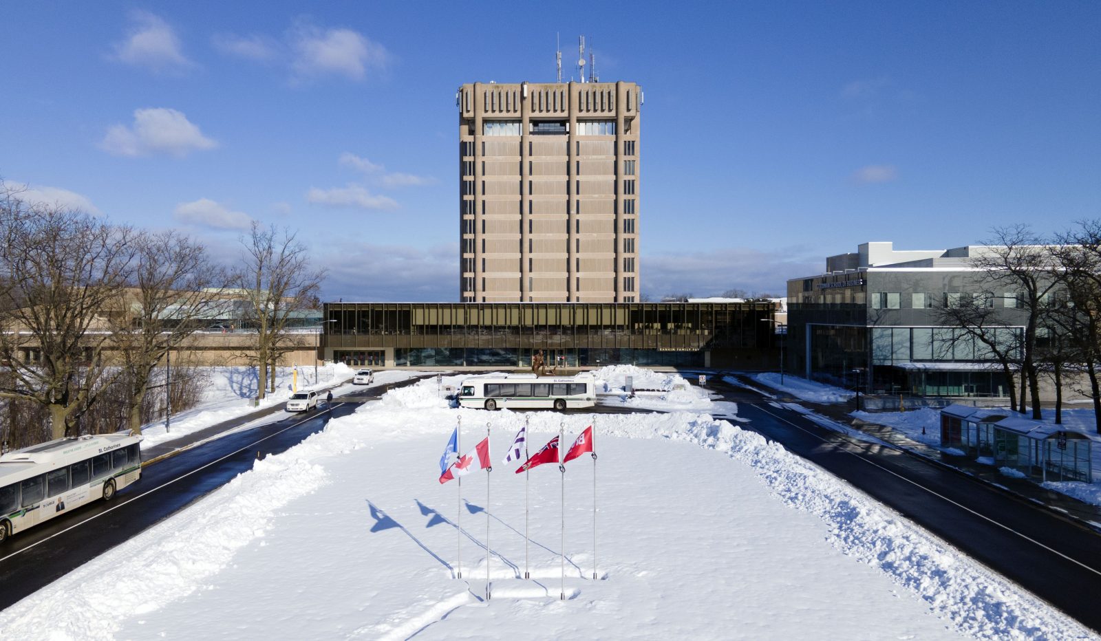 Brock University's Schmon Tower in front of a field of snow.