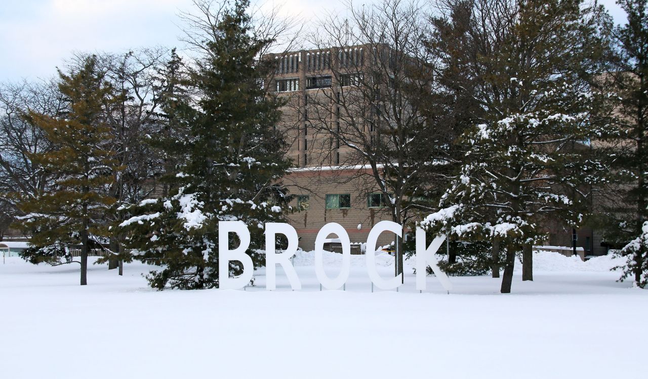 Large white Brock sign on the University's main campus
