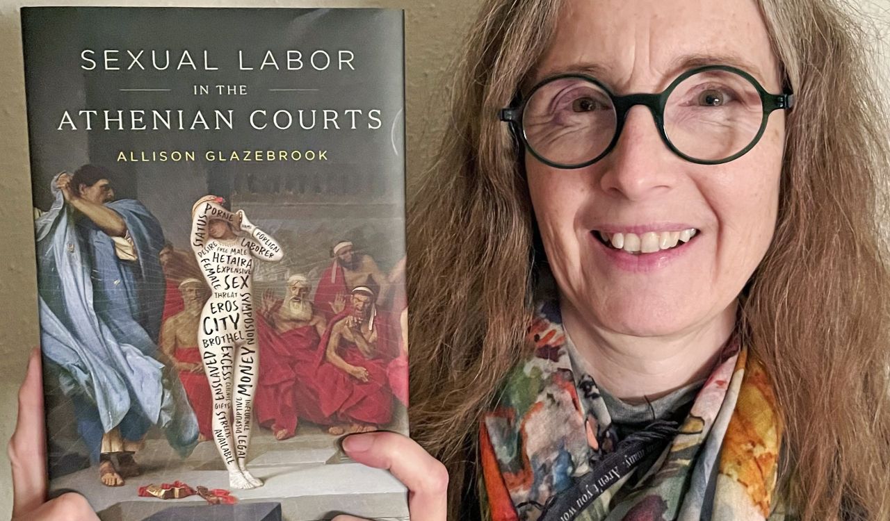 Allison Glazebrook, a Professor with the Department of Classics and Archaeology, holds up her new book, Sexual Labor in the Athenian Courts.