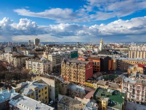 Cityscape of Kyiv, Ukraine, set against blue sky