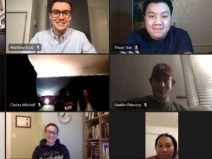 Screen capture of virtual meeting with several smiling faces in separate windows.