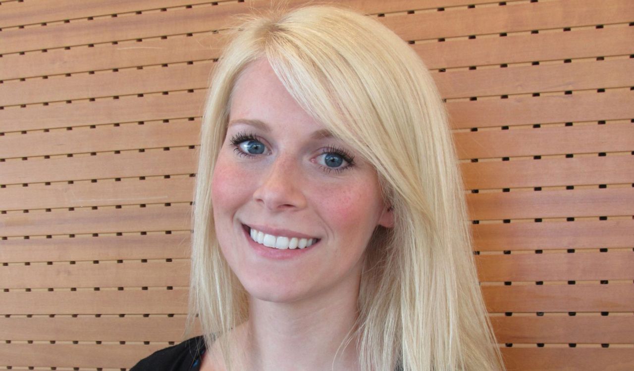 A head-and-shoulders photo of a blond woman smiling.